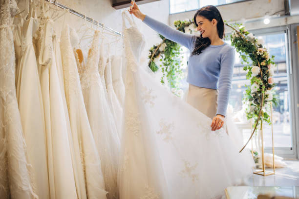 Bride to be looking at the wedding dresses at the bridal shop